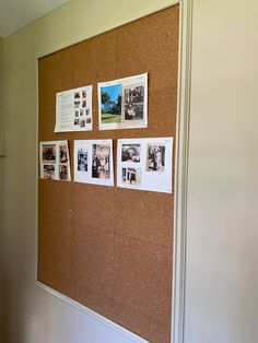 a cork board with pictures on it in an office building's entryway area