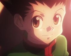 an anime character with brown eyes and green shirt looking at the camera while standing in front of a red light