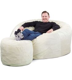 a man sitting in a bean bag chair with a stuffed animal on the bottom and legs