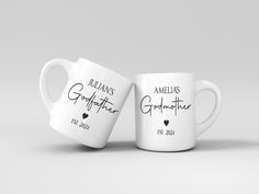 two white coffee mugs with names and hearts on them, sitting side by side