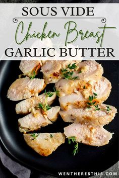 chicken breast with garlic butter on a black plate and text overlay reads sous vide chicken breast garlic butter