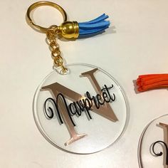 a keychain with the word'n'on it next to a pair of scissors