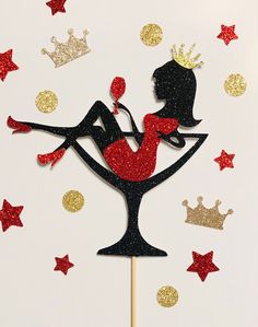 there is a cake topper that has a woman in a cocktail glass on it