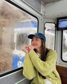 a woman sitting on a bus looking out the window