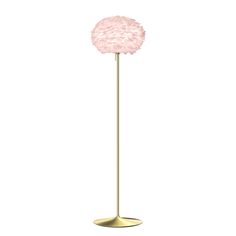 a gold floor lamp with a pink flower on the top and bottom, against a white background