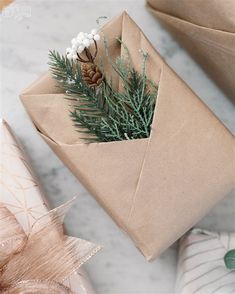 a wrapped present sitting on top of a table next to other wrapping paper and decorations