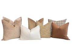 four different colored pillows sitting on top of each other