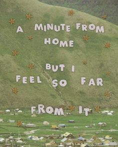 there is a sign on the side of a hill that says, a minute from home but i feel so far from it