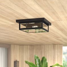 a ceiling light that is mounted to the ceiling in a room with wood paneling