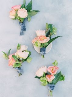 three bouquets of flowers are arranged on a table