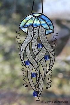 a stained glass sun catcher hanging from a window