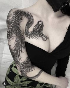 a woman with a dragon tattoo on her chest