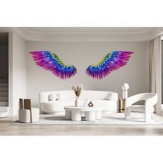 a living room with white furniture and colorful wings on the wall