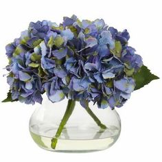 a vase filled with blue flowers on top of a table