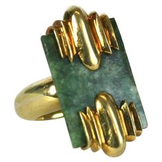 Jade and 18k Gold Modernist Ring with Art Deco overtones. The mottled nephrite jade plaque is held by two large ribbed Deco panels, suspended over a heavy rounded, but, squared off ring shank. A mix of Deco Retro and Modernist overtones. Clean and striking in scale. Heavy 18k gold settings. Ring Size 7.5, Top measures 1 3/8" x .75". 1960's USA. Antique Cocktail Ring, Jade Jagger, Sapphire Cocktail Ring, Modernist Ring, Deco Retro, Nephrite Jade, Perfect Ring, Cocktail Rings, Amazing Jewelry