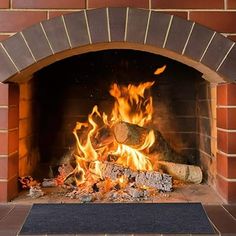 a fire burning in a brick fireplace with logs