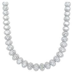 Stunning oval diamond tennis necklace east-west. High jewelry by Alexander Beverly Hills. 24.22 carats total diamond weight. 60 oval diamonds, 19.61 carats total. Approximately F/G color and SI1 clarity. Complimented with 959 round brilliant diamonds, 4.61 carats. Approximately D/E color and VS clarity. Four prong set in 18k white gold, 36.64 grams, 16 inches. Accommodated with an up-to-date digital appraisal by a GIA G.G. once purchased, upon request. Please contact us with any questions. Item Number NS1781 Diamond Tennis Necklace, Tennis Necklace, East West, Oval Diamond, High Jewelry, Item Number, Round Brilliant, Beverly Hills, Prong Setting