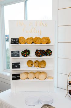 an assortment of pastries on display in front of a sign that says mr and mrs cauley