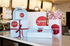 three boxes with red and white designs on them sitting on a counter in a kitchen