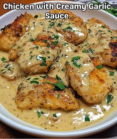 chicken with creamy garlic sauce on a white plate