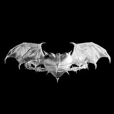 a black and white photo of a bat hanging upside down