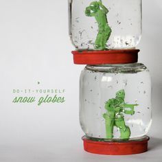 two glass jars with toy soldiers in them and the words do - it - yourself snow globes