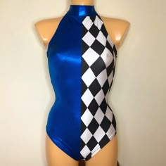 a mannequin wearing a blue and black one piece swimsuit with checkered squares on it