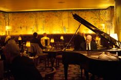 a man sitting at a piano in a restaurant