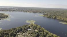 an aerial view of a lake surrounded by trees