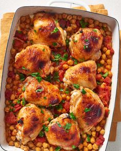 chicken and chickpeas in a white casserole dish with garnish