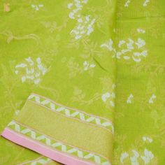 the fabric is green and white with pink trims on it, along with an intricate floral pattern