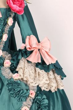 Revel in the grandeur of the past with our Emerald Baroque Style Gown, a resplendent tribute to the rococo and baroque eras. This majestic Victorian Ball Dress, reminiscent of Marie Antoinette's opulent wardrobe, is a symphony of lush emerald green and delicate blush accents. Adorned with artful floral appliqués and ornate lace, each detail is meticulously crafted to evoke the romance of an enchanted garden. The luxurious bows and ruffles are strategically placed to celebrate and flatter a plus- Victorian Ball Dress, Victorian Style Wedding Dress, Historical Outfits, Georgian Dress, Antique Wedding Dresses, Victorian Ball, Victorian Style Wedding, Rococo Dress, Antoinette Dress