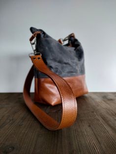 This waxed canvas and leather hobo bag is made with durable and first quality waxed canvas ( oilskin ) and Italian leather. If you are looking for a strong and versatile waxed canvas bag this crossbody hobo bag in waxed canvas and leather is perfect for you. If you love travel in the nature, well, this is your bag! Brown Canvas Bucket Bag With Leather Trim, Brown Coated Canvas Bucket Bag With Leather Handles, Leather Canvas Bag With Canvas Lining For On-the-go, Leather Bucket Bag With Leather Trim For On-the-go, Leather Bucket Shoulder Bag With Leather Trim, Leather Bucket Bag With Leather Trim, Leather Bucket Bag With Shoulder Strap, Everyday Hobo Bag With Adjustable Strap In Coated Canvas, Everyday Waxed Canvas Shoulder Bag With Leather Handles