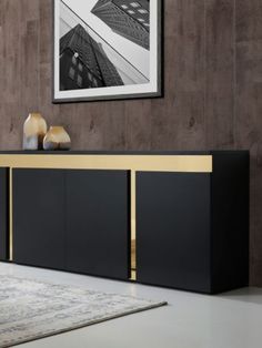 a black and gold sideboard in a living room with a painting on the wall