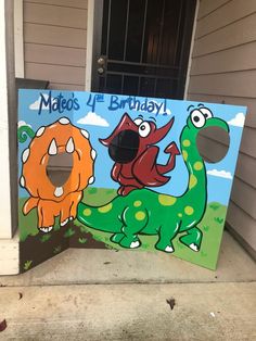 a cardboard birthday sign with two dinosaurs on it's front porch, and the words mao's 4 birthday written in large letters