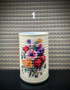 the number one candle holder has flowers painted on it