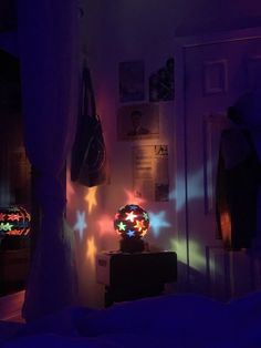 a bedroom with lights shining on the wall