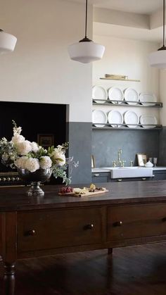 the kitchen is clean and ready to be used for cooking or baking, with flowers on the counter