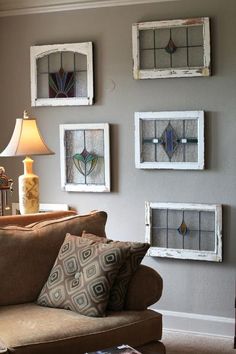 a living room filled with furniture and pictures hanging on the wall above it's coffee table