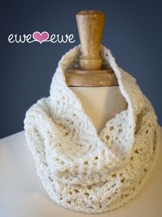 a white crocheted scarf on top of a mannequin