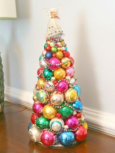 a christmas tree made out of ornaments on a table