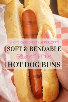 a person holding a hot dog with buns on it and the words soft & bendable gluten free hot dog buns