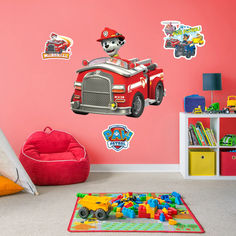 a child's bedroom decorated in pink and red with firetruck wall decals