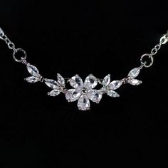 New to our Millennium collection, These beautiful romantic Swarovski Crystal Dainty Gilded Flora Serenade necklace are made of very fine quality of Swarovski crystals/ Cz diamonds and plated with platinum for your special day! Even we have hard time taking pictures because of their shine 😄 so we want to shine our brides on their special days. Simulated diamonds are also known as diamond simulants and include things like cubic zirconia (CZ), moissanite, and YAG. They can also include some natura Elegant Rhinestone Necklace With Adjustable Chain For Wedding, Silver Flower-shaped Necklace For Parties, Silver Flower Shaped Necklace For Party, Silver Necklace With Flower Shape For Party, Silver Flower Necklace With Clavicle Chain For Parties, Elegant Flower Necklace With Clavicle Chain For Party, White Crystal Necklace With Flower Pendant, Delicate Crystal Necklace For Formal Occasions, White Crystal Flower Pendant Necklace