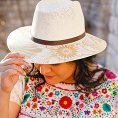 These unique and stylish artisanal hats were hand painted by Alicia in Oaxaca, Mexico. Each hat displays vibrant and fun designs that take hours to create and so versatile you can wear year-round. Our unique, curated design selections offer a modern touch to the traditional Mexican designs and will complement many fashion styles. Size: Medium 22.8 inches. One size fit most; hat features an internal elastic band for comfort. Materials: Painted jute. The hat brim features a leather band and colors Bohemian Hand Painted Panama Hat With Flat Brim, Artisan Wide Brim Panama Hat, Traditional Curved Brim Hat For Cinco De Mayo, White Artisan Hand Painted Hats, White Artisan Hat With Short Brim, Artisan White Hat With Short Brim, Adjustable Hand Painted Panama Hat With Curved Brim, White Artisan Sun Hat With Flat Brim, Artisan Wide Brim Sun Hat Hand Painted