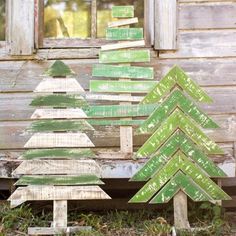 three wooden christmas trees sitting next to each other