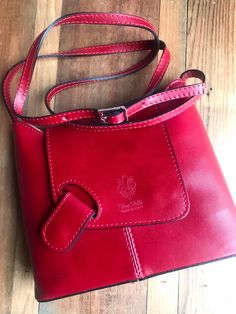 The spectacular stitching, magnetic clasp and deep rich color make this handbag a standout. The wide bottom makes this quite a roomy handbag at 9.5 inches long by 7.5 inches high. The zip closure adds extra protection. Stamped “Vera Pelle” - signifying genuine Italian leather & made in Italy. #leathershoulderbag #leatherhandbags #leatherhandbagswomen #leatherhandbagpurse #leathercrossbodybag #leatherpurses #verapelle Chic Flap Bag With Cell Phone Pocket, Leather Flap Bag With Detachable Strap, Leather Flap Bag With Magnetic Closure For On-the-go, Red Leather Shoulder Bag With Cell Phone Pocket, Chic Leather Bag With Cell Phone Pocket, Everyday Leather Flap Bag With Magnetic Closure, Leather Flap Bag With Magnetic Closure For Everyday Use, Flap Bag With Cell Phone Pocket For On-the-go, Versatile Leather Flap Bag