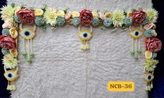 an image of flowers and evil eye decorations on the wall in front of a rug