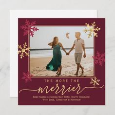 a holiday card with an image of two people holding hands and the words, the more the merrier