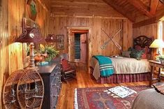 a bedroom with wood walls and wooden floors